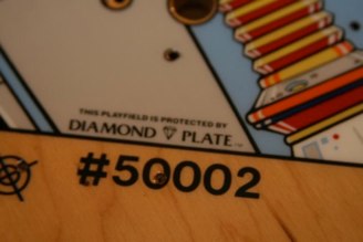 Bride of Pinbot, rare factory clear coated version.<br />This playfield was made by Sun Process. About 200 of these factory Diamond Plate playfields were made. Most BOP playfields had a lacquer coating on them.